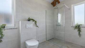 Shower, hair dryer, towels, toilet paper