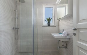 Shower, hair dryer, towels, toilet paper