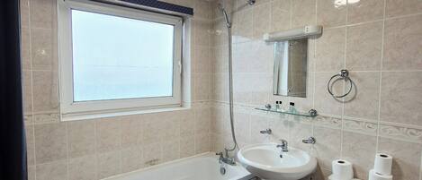 A modern bathroom with a bathtub, sink, and toilet.