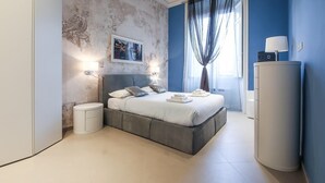A modern bedroom with a large bed, a wardrobe, a bedside table, and a wall-mounted TV.