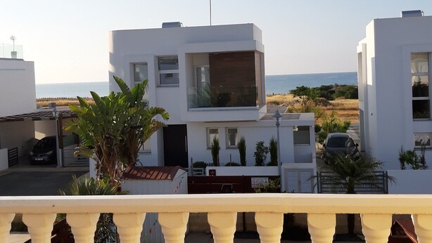 A modern white building with a large window and a balcony with a railing. - The Carolyn villa in Ayia Napa has everything you need for an enjoyable holiday (AYIA NAPA)