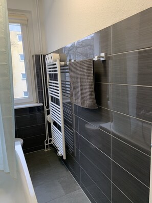 Combined shower/bathtub, hair dryer, soap, toilet paper