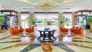 A lobby with a chandelier, seating area, and a view of the outdoors. - Fantazia Marsa Alam Resort (Marsa Alam)
