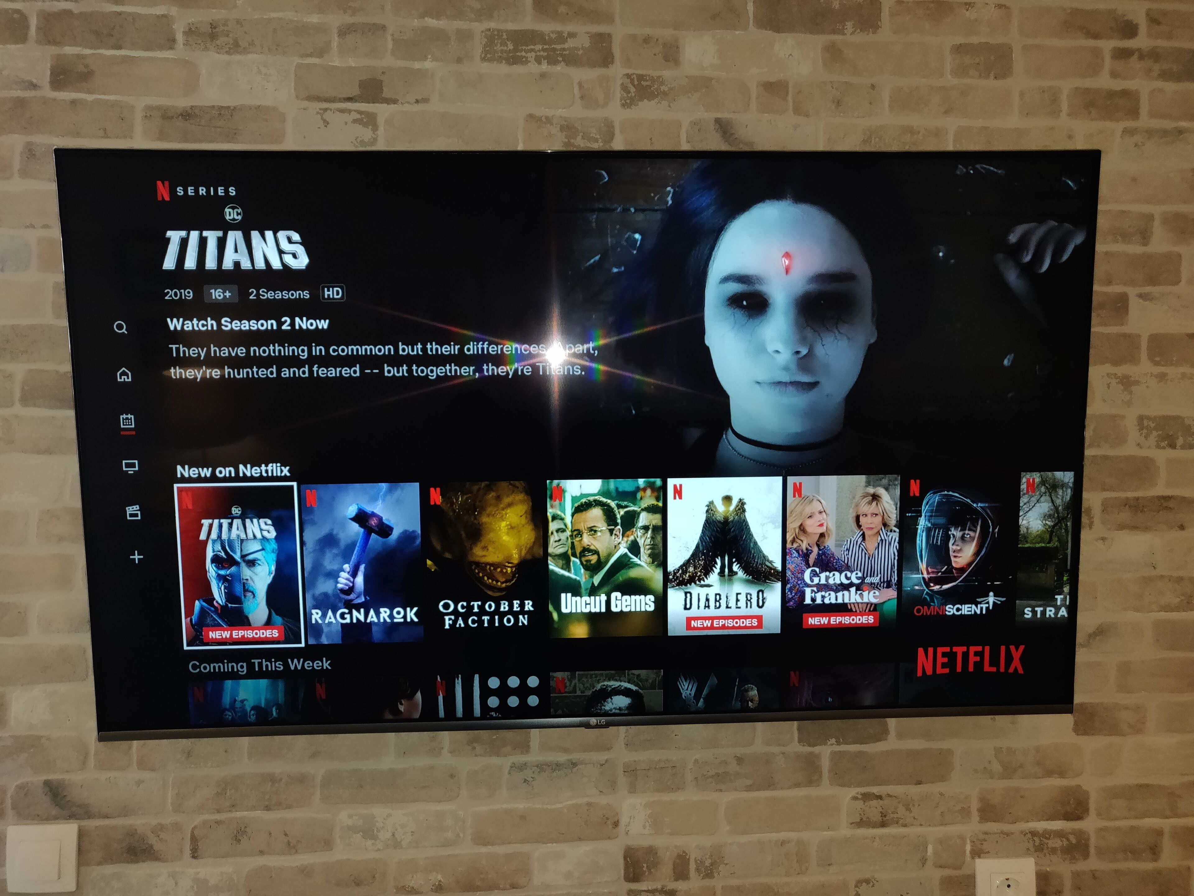 A television screen displaying a Netflix interface with various show options.