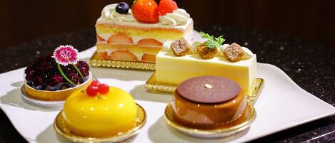 A variety of desserts on a white plate.