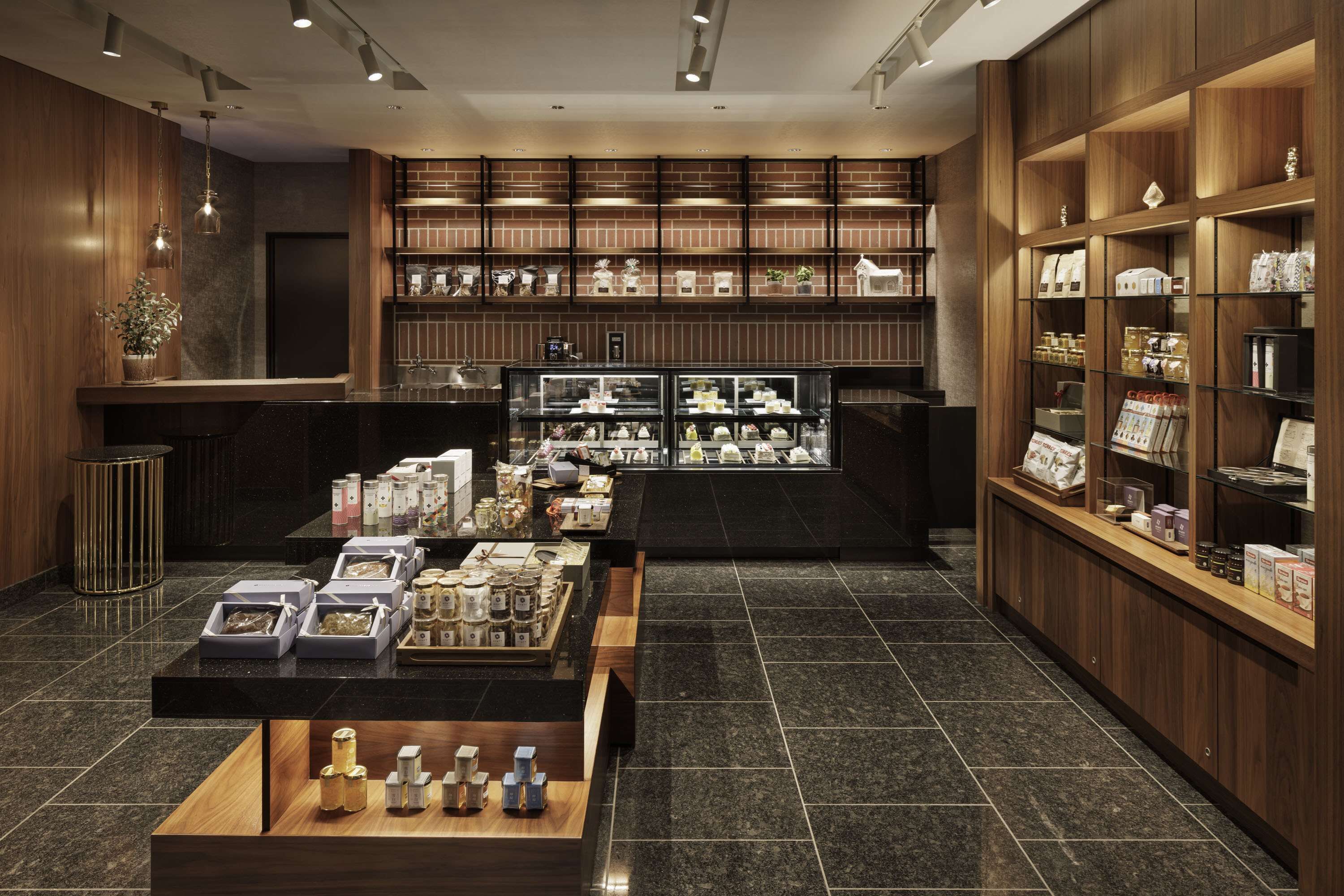 A well-lit retail space with wooden shelving and display cases containing various products.