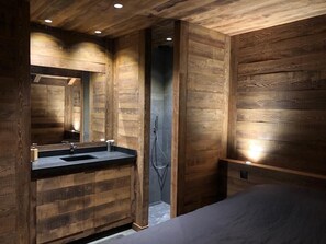 A modern bathroom with wooden paneling, a sink, and a shower. - Chalet Near the slopes, wellness area  (La Salle-les-Alpes)