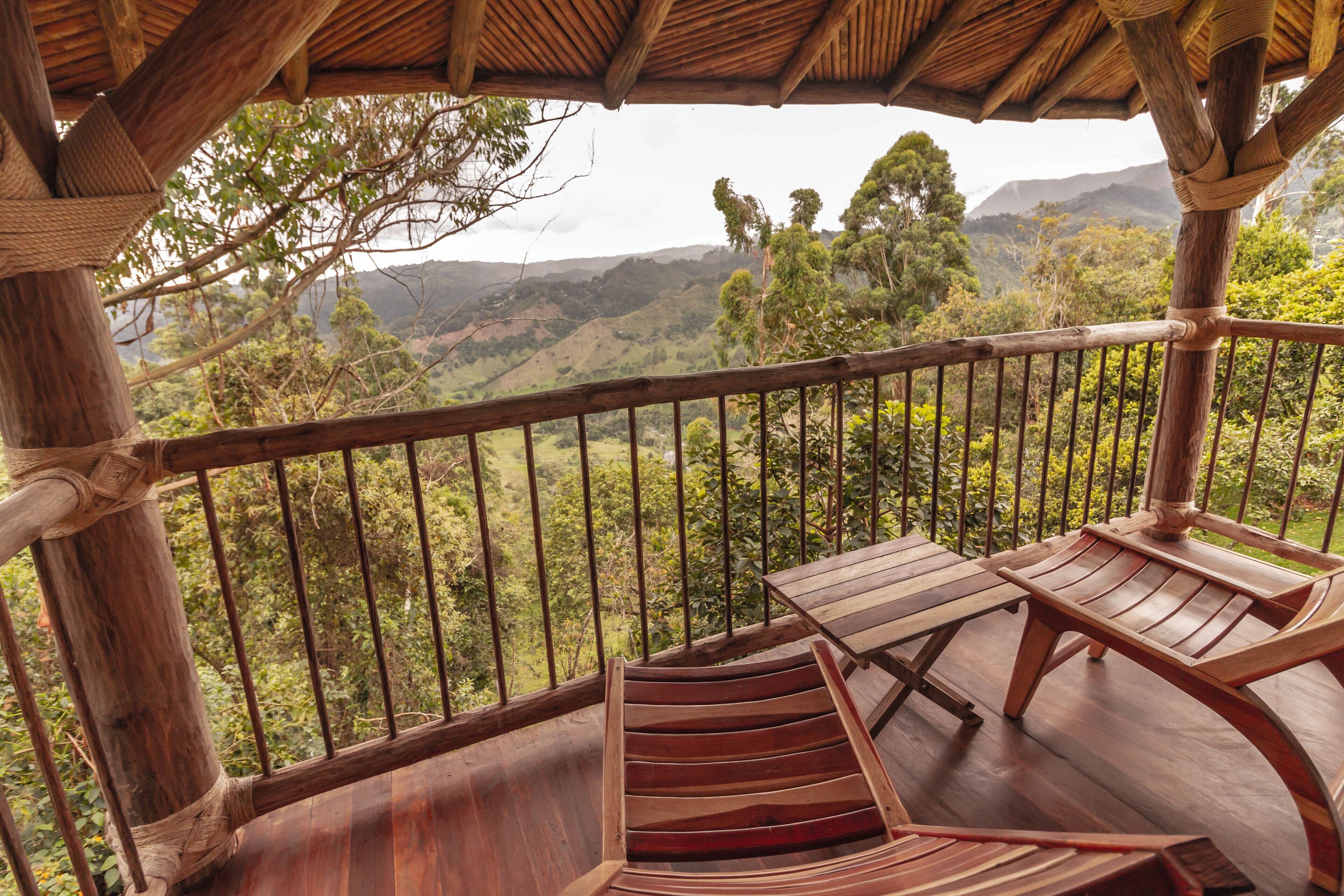 A wooden deck with a view of a mountainous landscape.