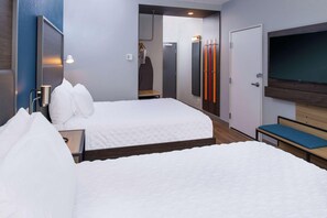 A hotel room with two beds, a TV, a wardrobe, and a mirror. - Tru By Hilton Elkhart (Elkhart)