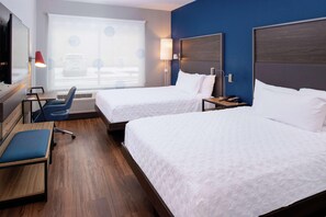 A hotel room with two beds, a desk, a chair, and a large window with blinds. - Tru By Hilton Elkhart (Elkhart)