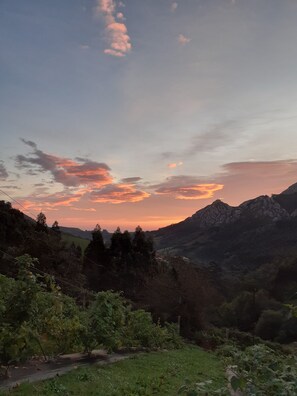 Un paisaje montañoso con un atardecer.