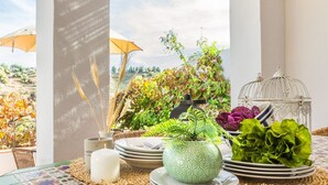A table set with plates, a candle, and a potted plant.