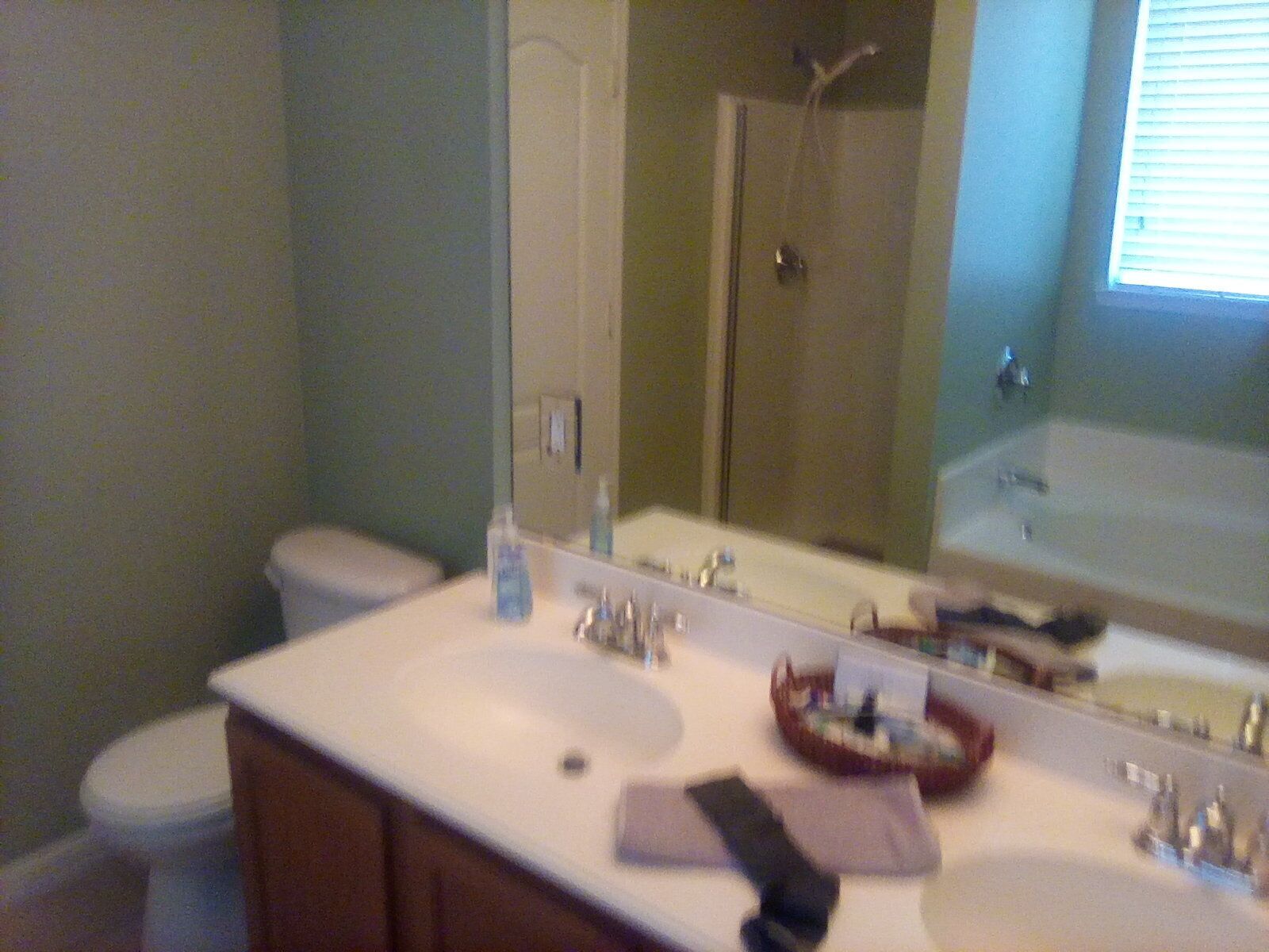 A bathroom with a white sink, a mirror, and a shower.