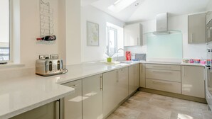 Eine moderne Küche mit Arbeitsplatte, Toaster, Spüle und Schränken.