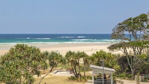 A beach view with a gazebo and palm trees. - OCEAN VIEWS @ NOR NOR EAST 201 (KINGSCLIFF)