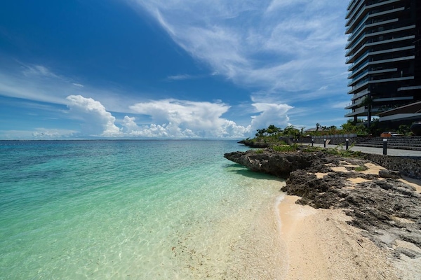 Private beach, white sand, sun loungers, beach umbrellas