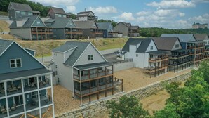 A residential area with modern houses featuring balconies and large windows. - 7 BR, 7.5 Bath Home with Hot Tub close to all of the Branson Fun! (Branson)