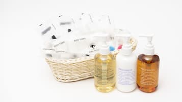 A basket of toiletries including body towels, a toothbrush, and bottles of Provinscia products.