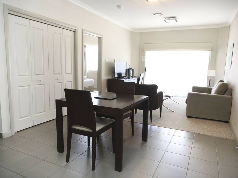 Un espacio habitable compacto con comedor, sofá y kitchenette.