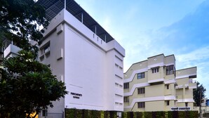 A modern building with a flat roof and a gated entrance. - Panchavati Express (Nashik)