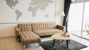 A modern living room with a sofa, a coffee table, and a world map on the wall. - KSL D’Esplanade by Antlerzone (Johor Bahru)