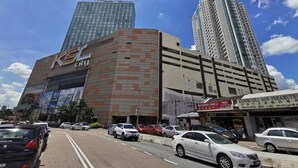A multi-story building with a prominent 'KFC' sign, adjacent to a tall skyscraper and a smaller commercial building with a 'Restoran Sing Li' sign. - KSL D’Esplanade by Antlerzone (Johor Bahru)
