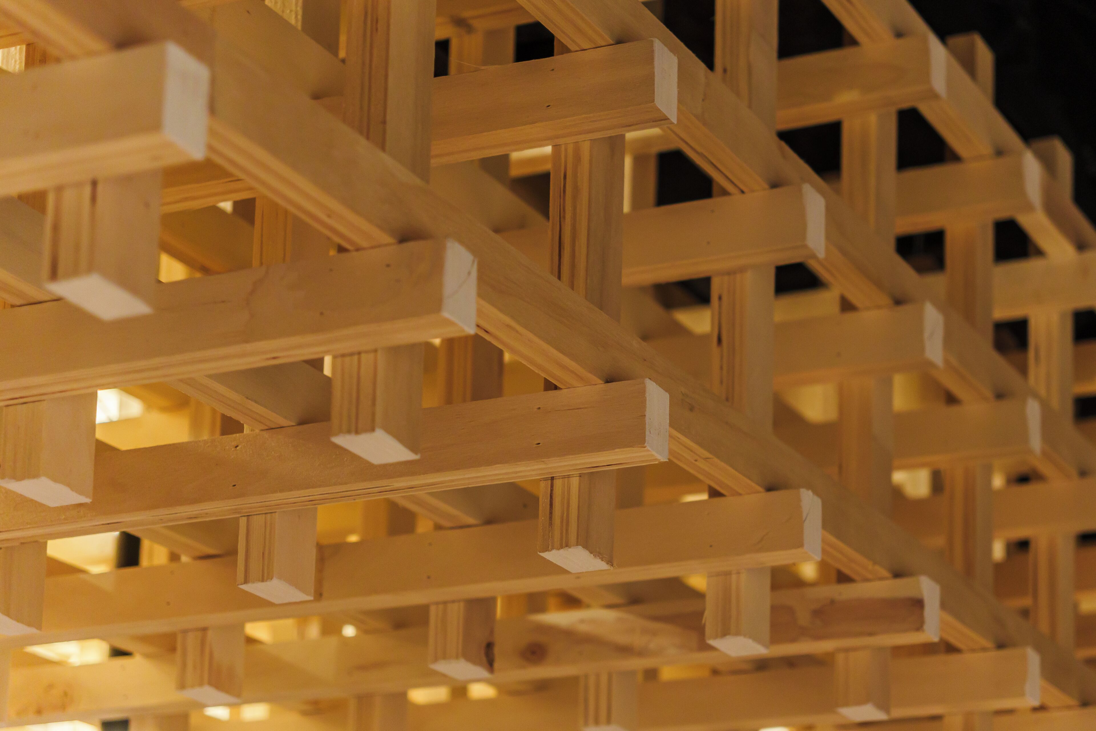 A close-up of wooden beams forming a lattice structure.