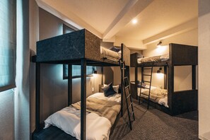 A bunk bed room with a ladder, a window with curtains, and a wall-mounted light. - BAKURO - DOYANEN HOTELS (Osaka)