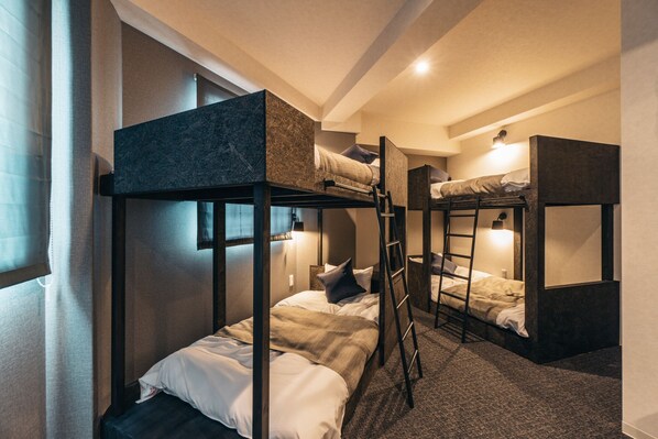 A bunk bed room with a ladder, a window with curtains, and a wall-mounted light. - BAKURO - DOYANEN HOTELS (Osaka)