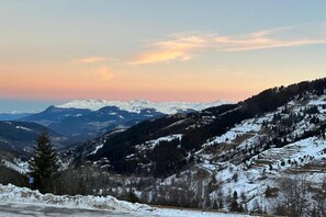 A snow-covered mountain landscape with a winding road. - Apartment by Table Verte Lift (Les allues)