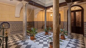 A spacious lobby with checkered flooring, ornate columns, and decorative wall panels. - Mirador San Jeronimo-Cathedral CTH Granada (Granada)