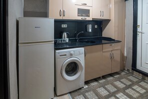 Economy Apartment | Private kitchen | Fridge, oven, electric kettle, dining tables