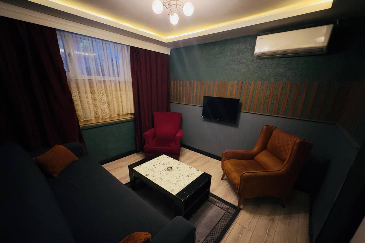 A modern living room with a sofa, armchair, and a coffee table.