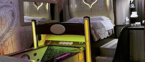 Un dormitorio con cama, tocador y espejo.