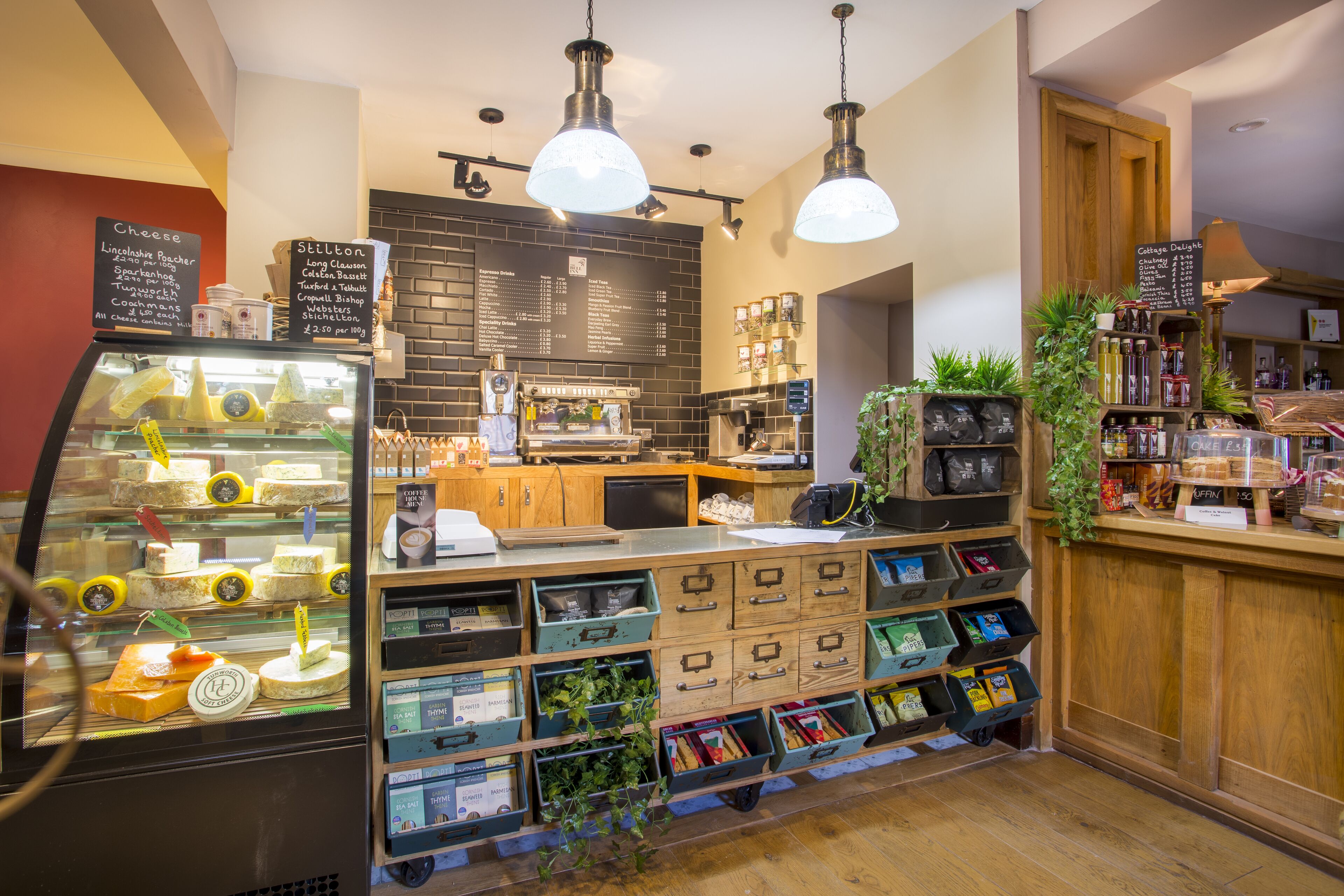 A bakery counter with a display case of pastries and a menu board listing items.