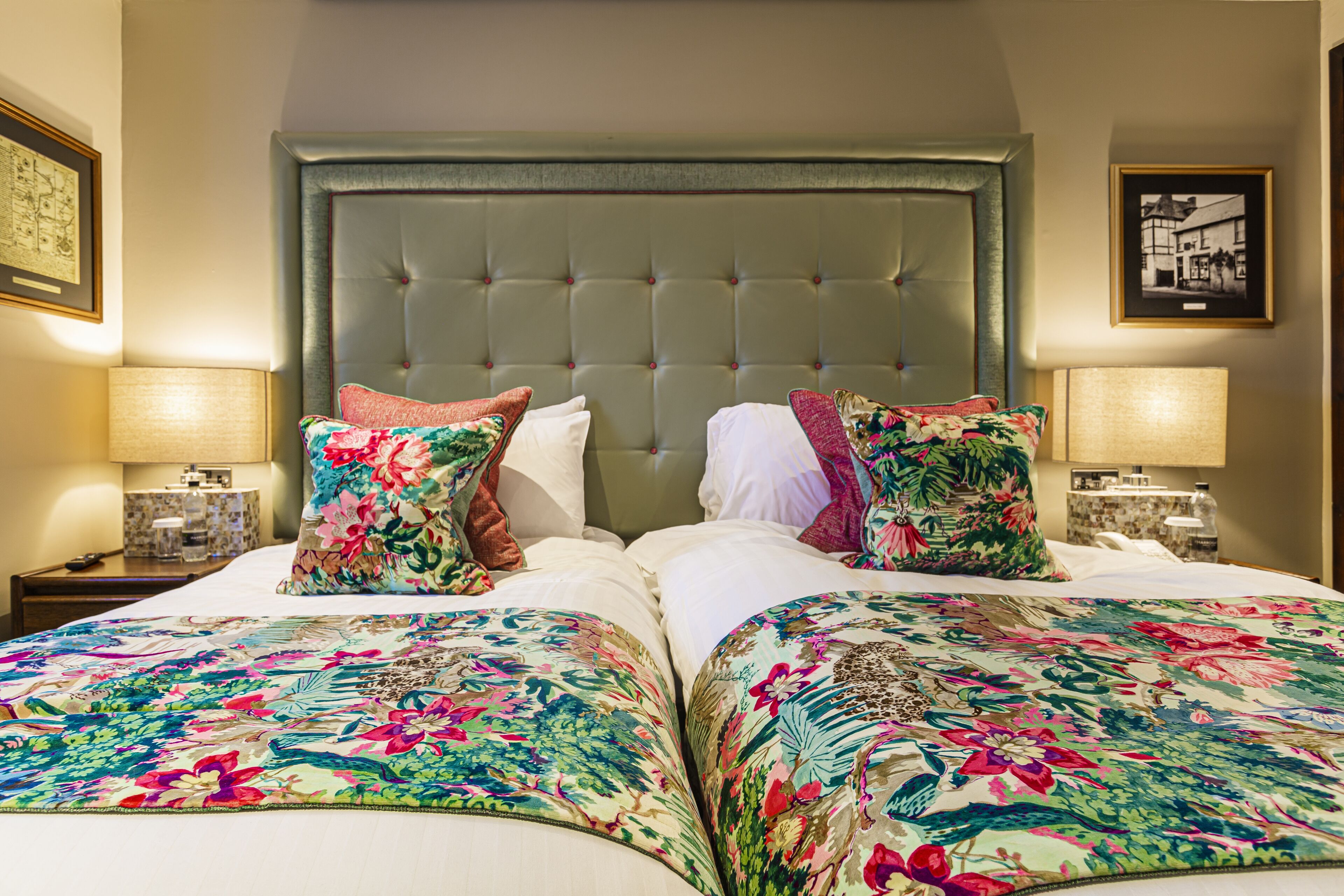 A hotel room with a large bed, two nightstands, and a headboard with a tufted design.