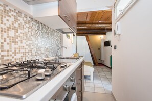Cozy Panoramic Studio with Loft Bed, Rooftop | Private kitchen | Full-size fridge, oven, stovetop, cookware/dishes/utensils - Il Garbino Suite and Apartment (Lecce)