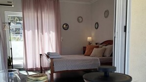 A cozy room with a bed, a table with a coffee maker, and a window with curtains. - Acropolis View Charming Loft (Athens)