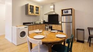A compact kitchen with a washing machine, a microwave, and a stainless steel refrigerator. - Central apartment for 4-9 people with parking in Cauterets (Cauterets)