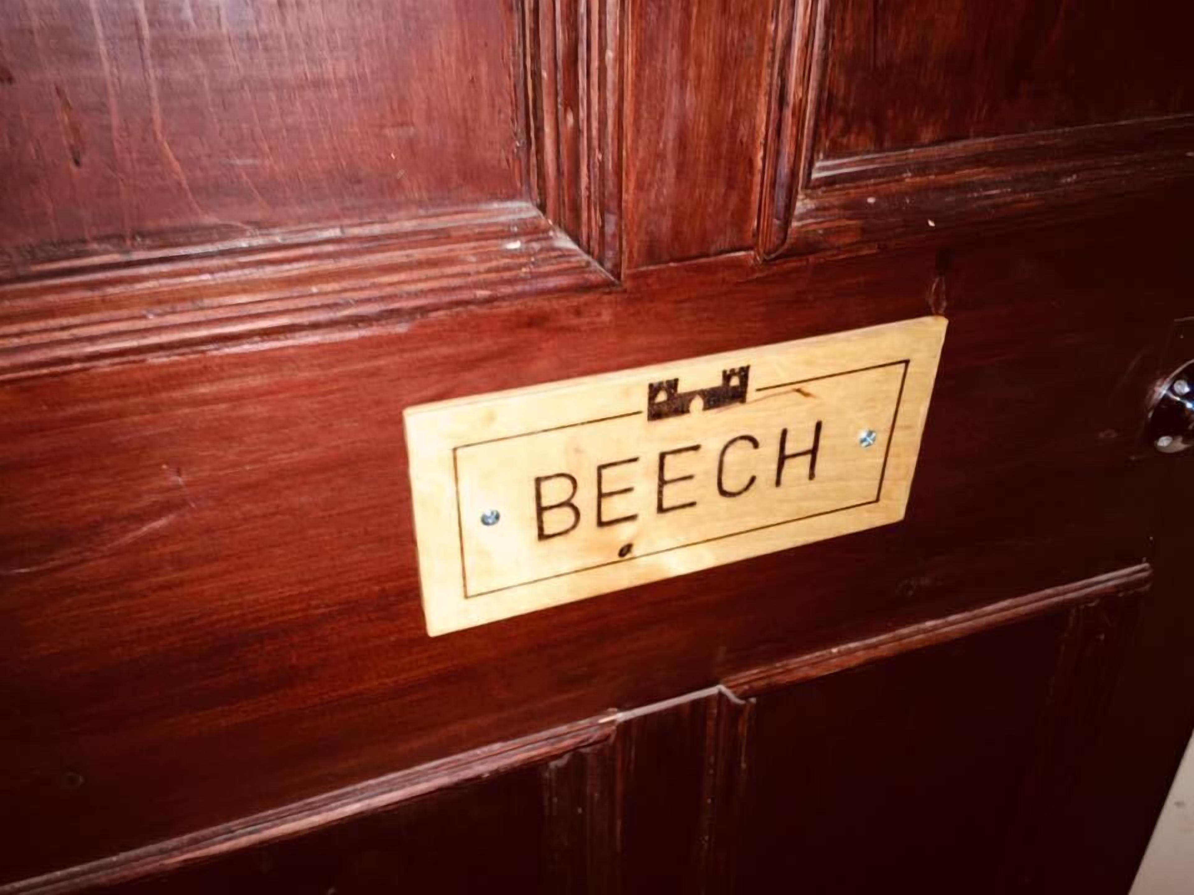 A wooden door with a plaque that reads "BEECH".