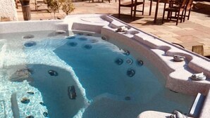 A hot tub with a wooden deck surrounding it. - Brass Castle Country House Accommodation (Middlesbrough)