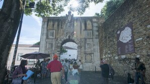 Una entrada con arcos de piedra y una multitud de personas.