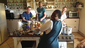 A kitchen with a central island, a stove, and a dog lying on the floor. - Stoneybrooke farm (Tierpoort)
