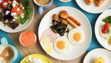 A breakfast spread with various dishes including eggs, toast, and a salad.