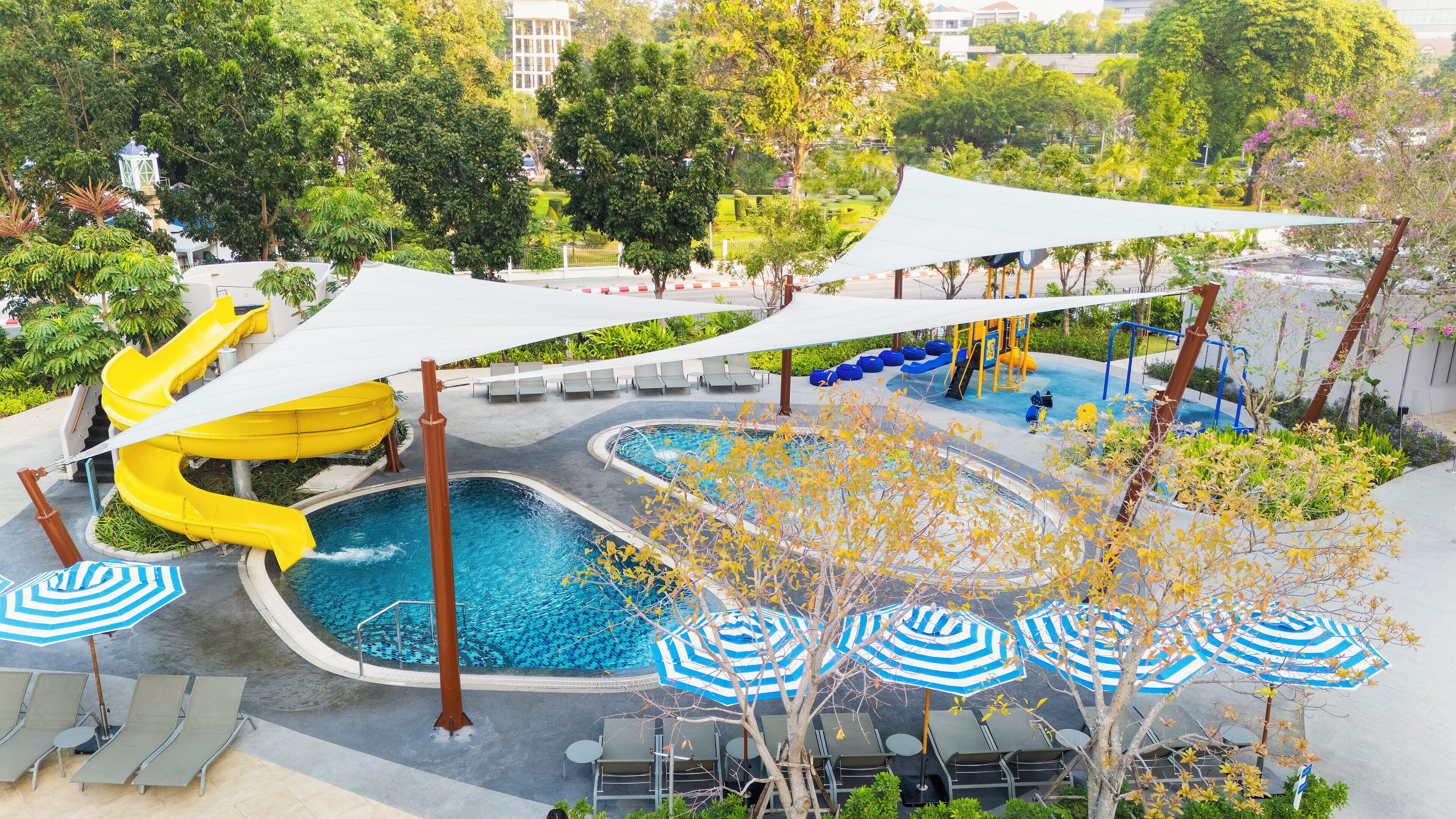 A water park with slides, a pool, and sun loungers.