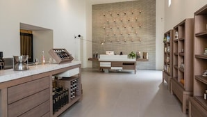 A modern kitchen with a wine rack, a coffee machine, and a countertop with bottles. - Chateau Mentone (Saint-Antonin-du-Var)