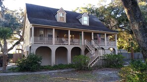 A two-story house with a porch, a staircase, and an American flag. - Peaches and Beaches.... come eat some fresh peaches, close to the island beaches (Saint Marys)