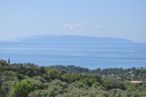 A coastal landscape with a view of the sea and distant mountains. - Diana Suites (Kefalonia)