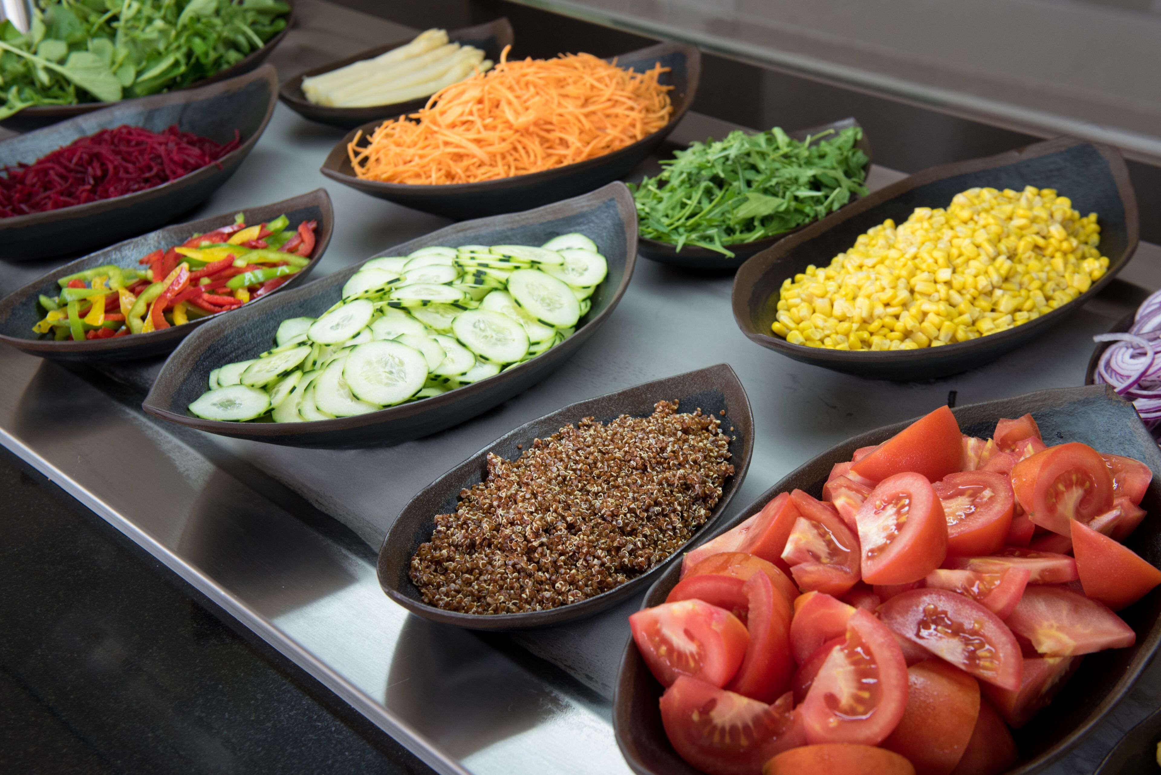 A buffet with various vegetables and fruits.