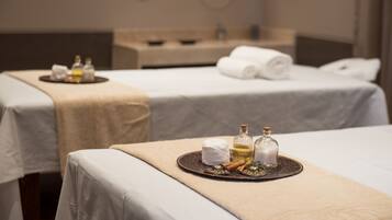 Two beds with beige bedspreads and decorative trays offer a serene retreat.